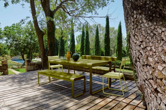Outdoor dining table with benches on deck