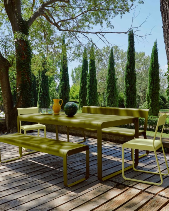 Outdoor dining table with benches on deck