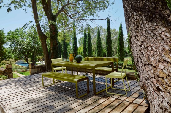 Outdoor dining table with benches on deck