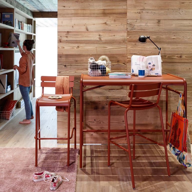 Fermob Luxembourg aluminium high bar table and bar stools in Red Ochre indoors