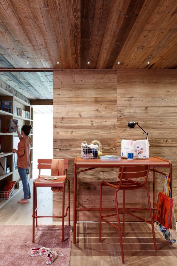 Fermob Luxembourg aluminium high bar table and bar stools in Red Ochre indoors
