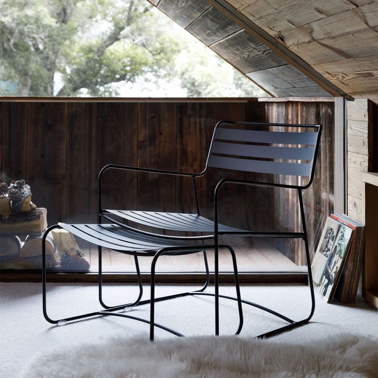 Fermob Surprising Low Armchair and Footrest in Liquorice in a winter cabin