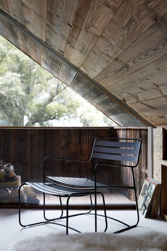 Fermob Surprising Low Armchair and Footrest in Liquorice in a winter cabin